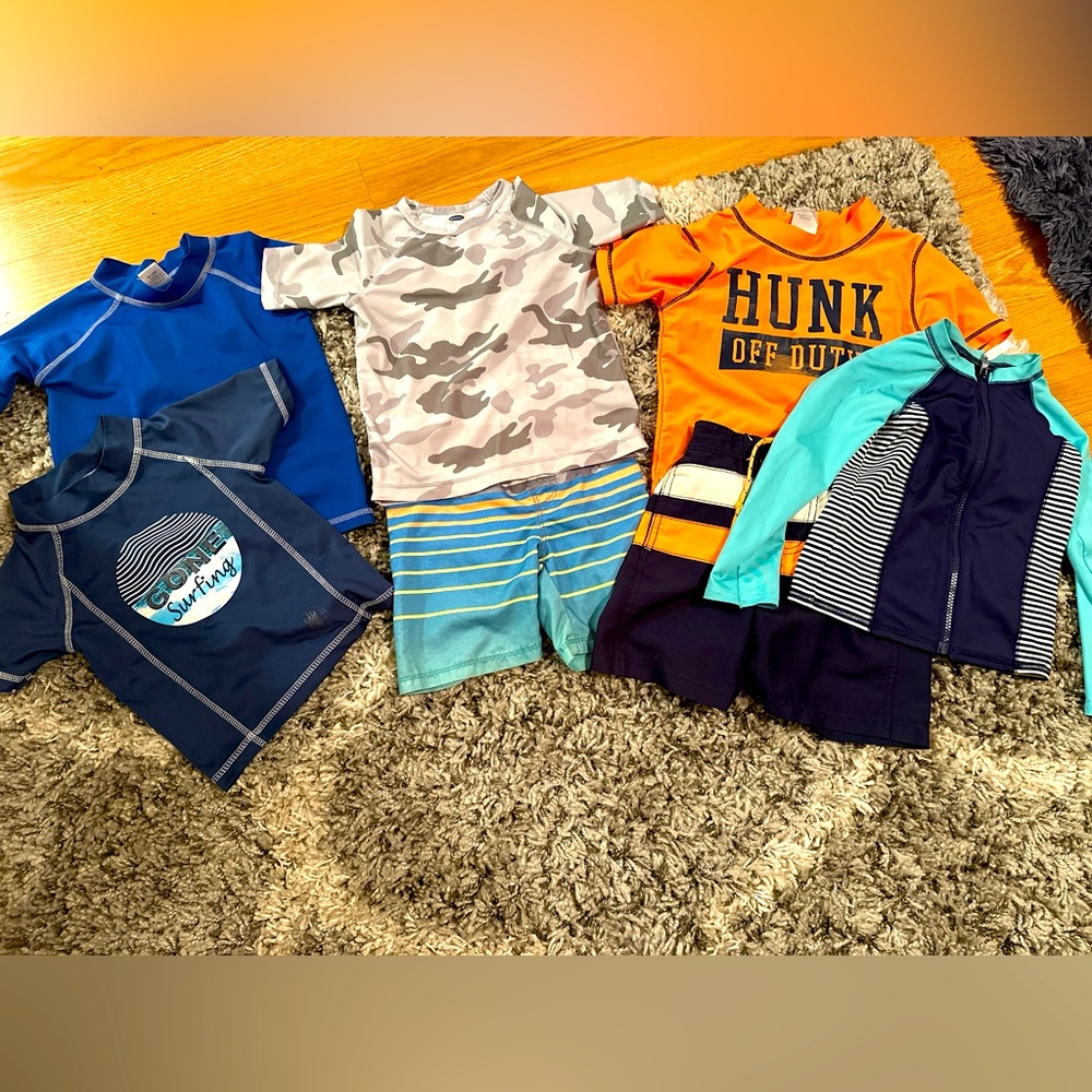 Boys 4T swim suits. Includes 5 mix and match rash guards and board shorts.